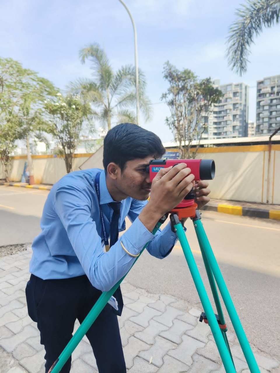 Abhishek Giri using a surveying instrument during field work